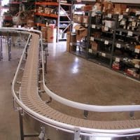 Model 2500 curved conveyor on shop floor. FEI Conveyors.