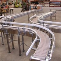 Model 2510 S-curve conveyors on shop floor. FEI Conveyors.